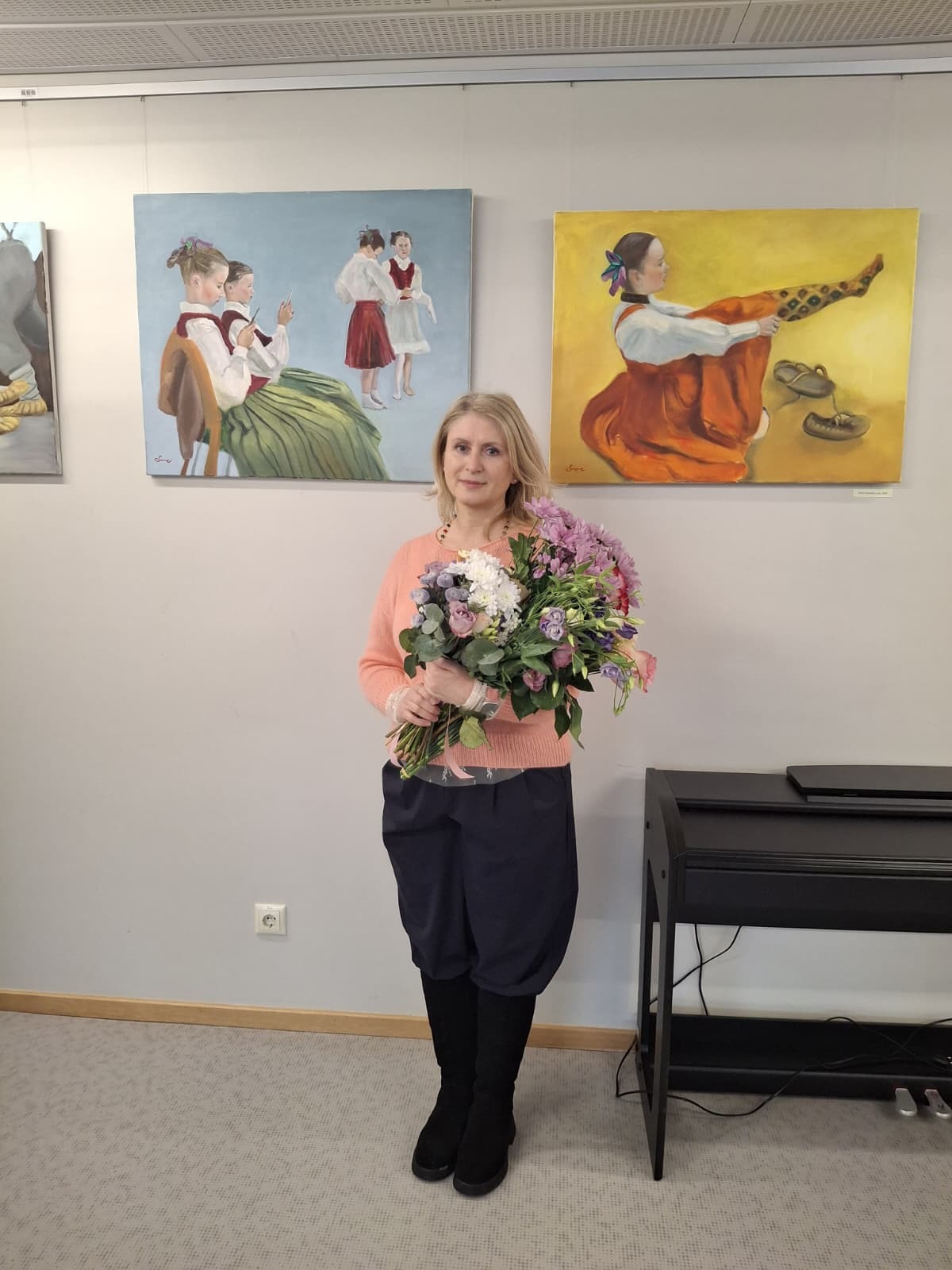 māksliniece ar ziediem pēc izstādes atklāšanas