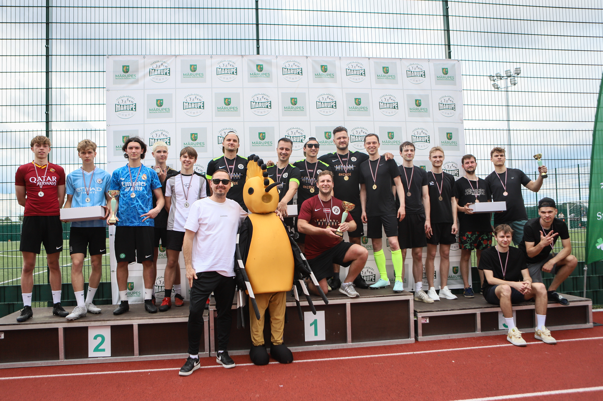 Sportisti uz apbalvošanas pjedestāla
