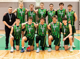 Vairāki sportisti stāv zālē ar sudraba medaļām kaklā