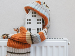 Simbolisks attēls, kas attaino radiatoru un māju ar šalli